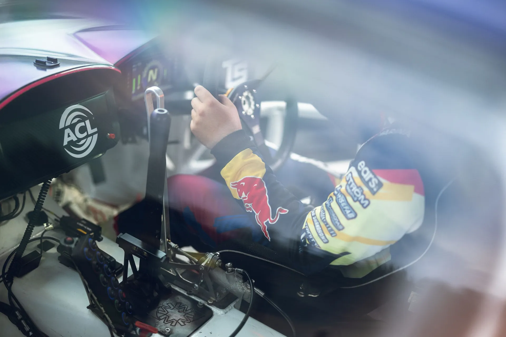 Driver at the wheel inside a Trinity Racing Team drift car